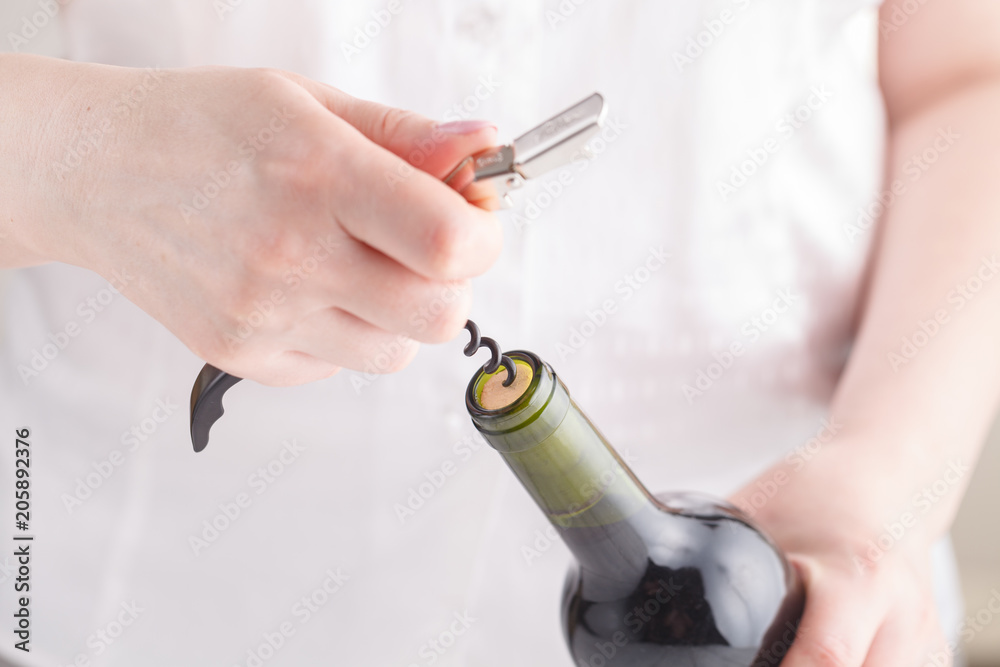 Opening wine bottle with a corkscrew