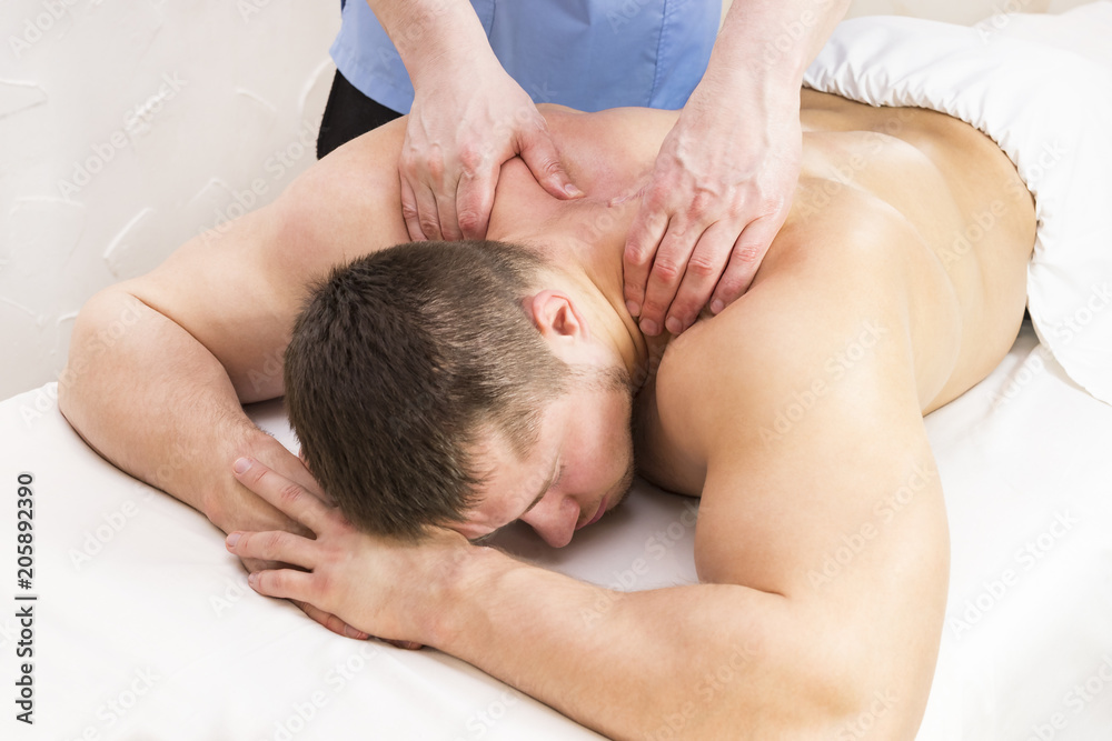 Young man on wellness treatments sports massage Young man on wellness treatments sports massage