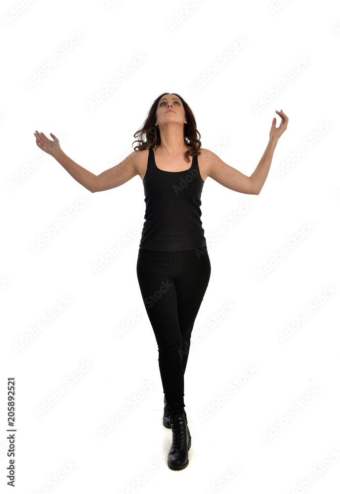full length portrait of brunette girl wearing black singlet, jeans jeans and boots. standing pose, isolated on white studio background. full length portrait of brunette girl wearing black singlet, jeans jeans and boots. standing pose, isolated on white studio background.