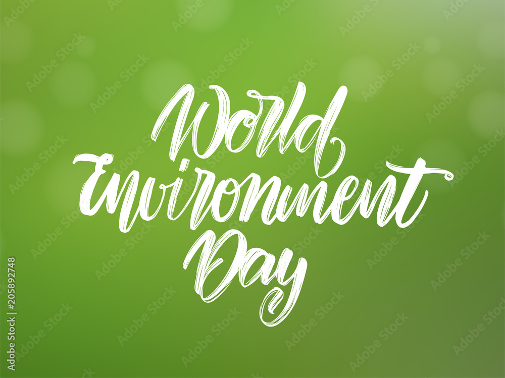 Handwritten type lettering composition of World Environment Day on green blurred nature background