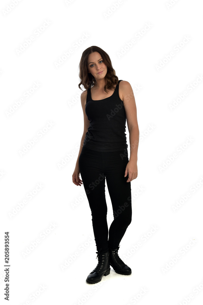 full length portrait of brunette girl wearing black singlet, jeans jeans and boots. standing pose, isolated on white studio background. full length portrait of brunette girl wearing black singlet, jeans jeans and boots. standing pose, isolated on white studio background.
