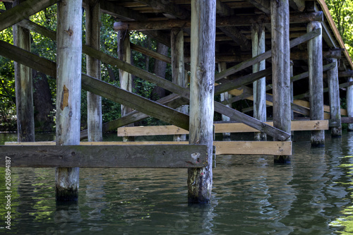 Wooden construction under bridge. Vintage bridge bottom view.
