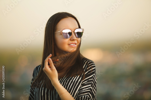 portrait of a young girl in sunglasses with reflective glasses.