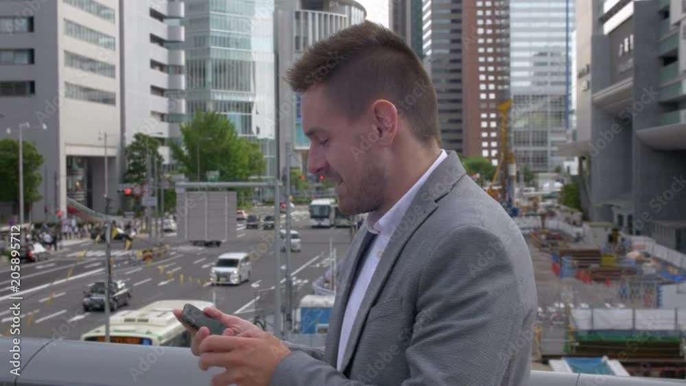 Caucasian business man gets good news on his smart phone. Caucasian business man gets good news on his smart phone.