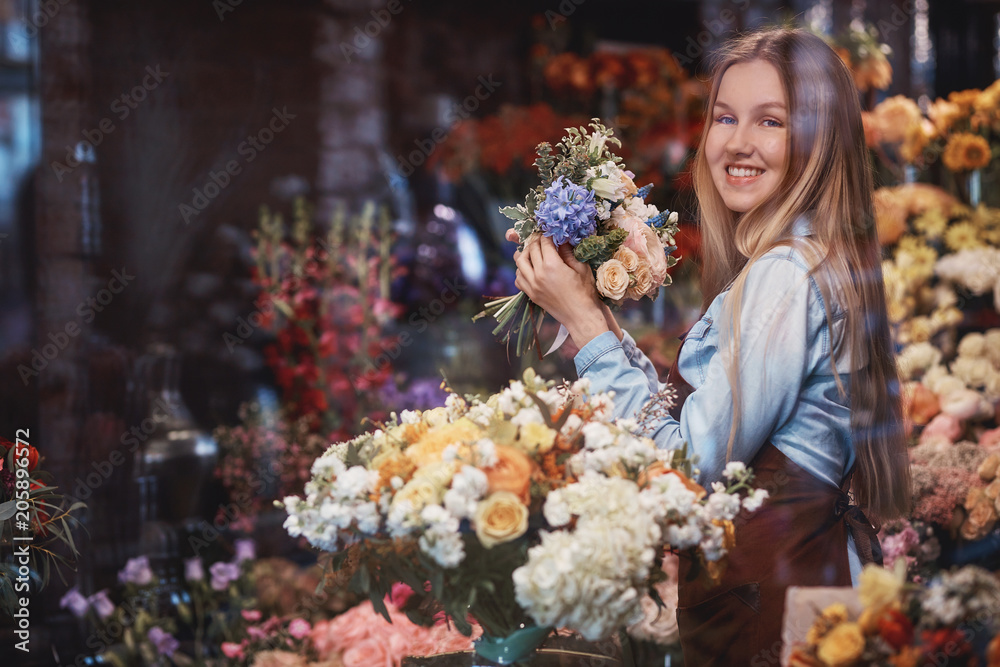 Smiling young florist with flowers