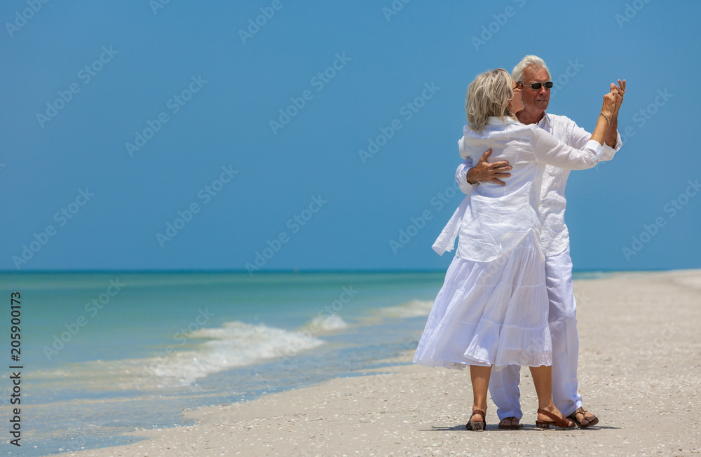 Happy Senior Couple Dancing Holding Hands on A Tropical Beach Happy Senior Couple Dancing Holding Hands on A Tropical Beach
