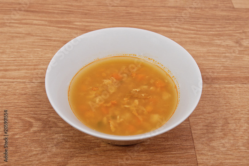 Groat soup with vegetables on a table