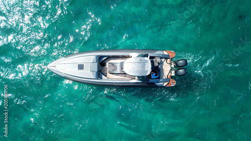 Aerial photo of luxury speed boat docked in tropical island with emerald crystal clear waters © aerial-drone