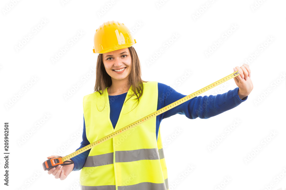 Young woman architect holding measuring tape. Young woman architect holding measuring tape.
