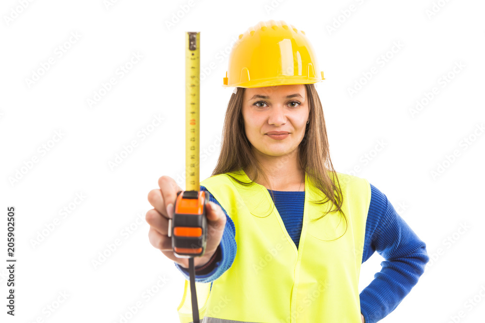 Young woman engineer holding measuring tape. Young woman engineer holding measuring tape.