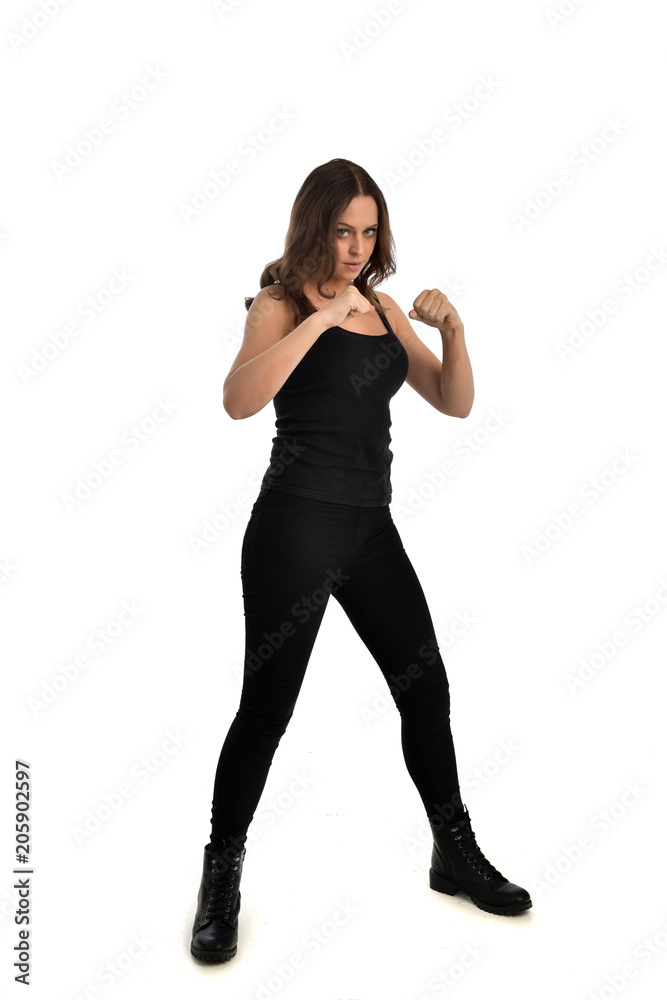 full length portrait of brunette girl wearing black singlet, jeans jeans and boots. standing pose, isolated on white studio background. full length portrait of brunette girl wearing black singlet, jeans jeans and boots. standing pose, isolated on white studio background.