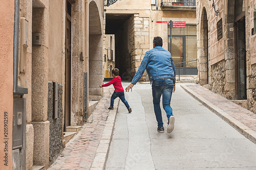 Father playing with his son in the street