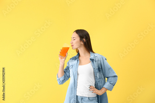 Young woman drinking orange...