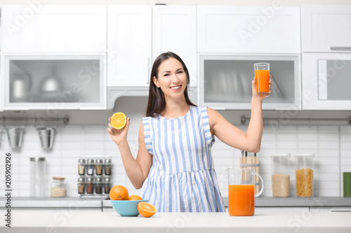 Young woman with glass of o...