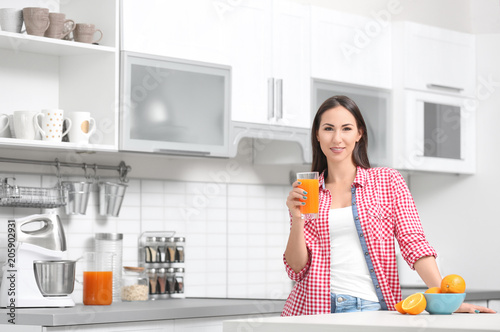 Young woman with glass of o...