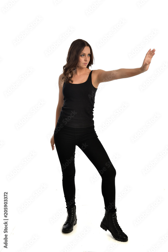 full length portrait of brunette girl wearing black singlet, jeans jeans and boots. standing pose, isolated on white studio background. full length portrait of brunette girl wearing black singlet, jeans jeans and boots. standing pose, isolated on white studio background.