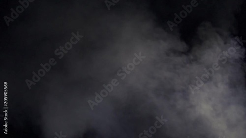 Smoke from a fire on a background of a dark night sky.