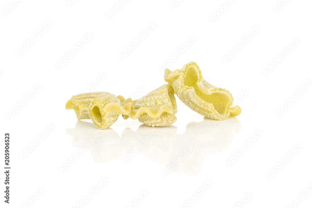Three pasta creste di gallo spinach raw isolated on white background. Three pasta creste di gallo spinach raw isolated on white background.