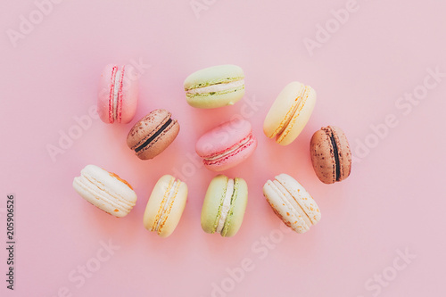 Wallpaper Mural stylish colorful macaroons on trendy pink paper, flat lay. space for text. modern food photography concept. tasty pink, yellow, green, white, brown macarons. yummy background Torontodigital.ca