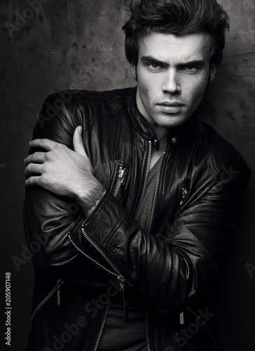 Fashion portrait of handsome young man in a black leather jacket © Bakulov