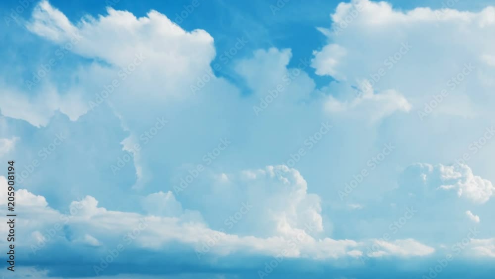 Time lapse white fluffy cumulus clouds flying, fast moving blue sky at cloudy summer day