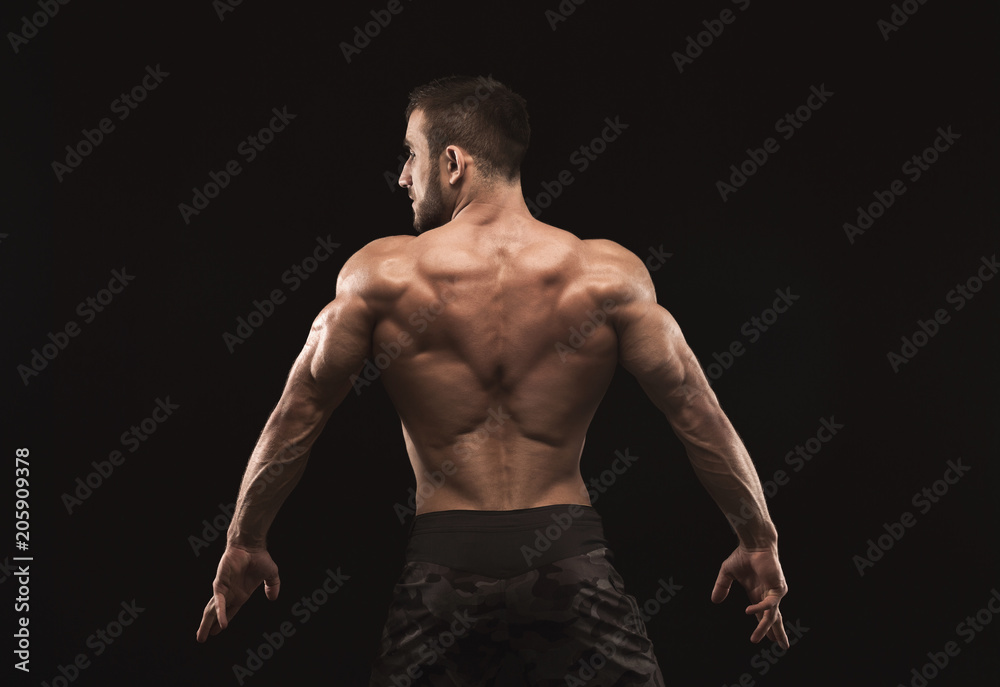 Fototapeta premium Unrecognizable man shows strong back muscles closeup