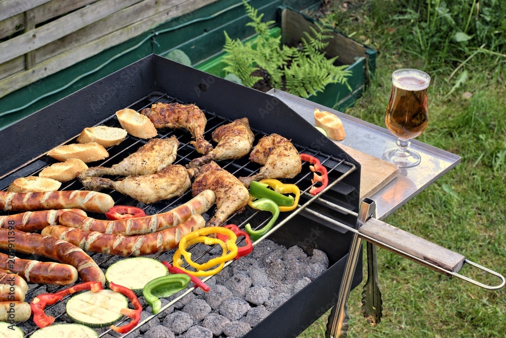 Tasty food, nutrition, culinary and barbecue concept: grilled sausages,chicken thigh and vegetables on a barbeque.