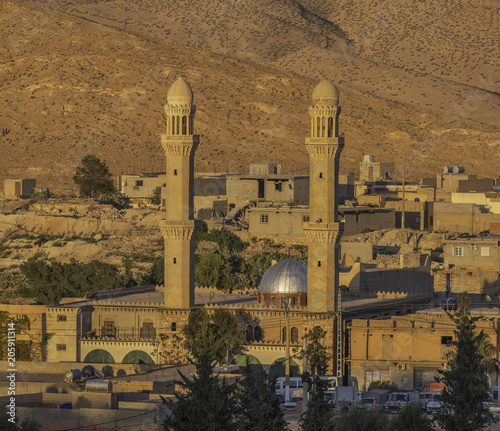 Mosque with two minarets in El Hamel near Bou Saada, Algeria photo