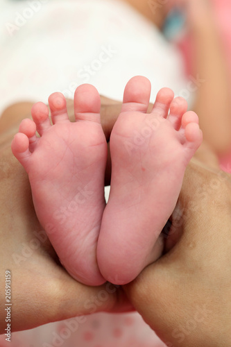 Tiny foot of newborn baby © godsandkings