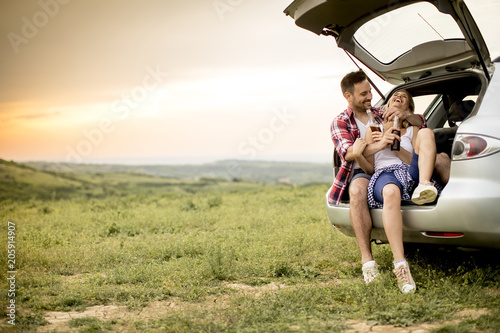 Loving couple sitting in the car trank © BGStock72