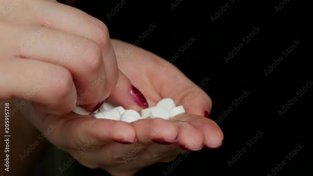 Concept of health. Medicine. A girl is holding a handful of pills Concept of health. Medicine. A girl is holding a handful of pills