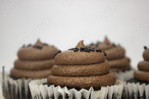 A chocolate cupcake on an isolated white background with room for text