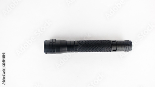 A black flashlight on an isolated white background