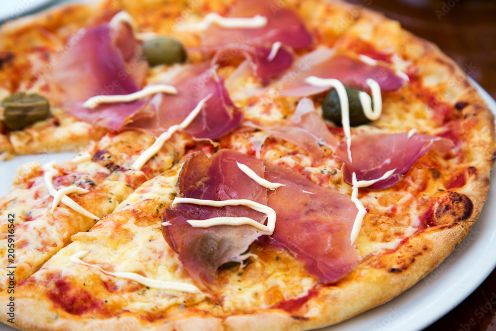Close up view of delicious pizza with prosciutto