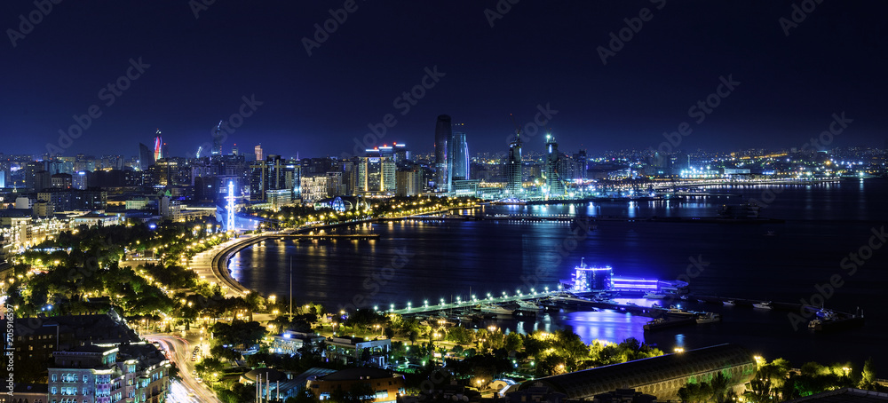 The skyline and Caspian Sea at night in Baku City, Azerbaijan