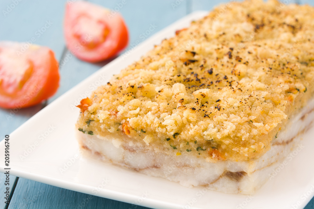 White fish casserole with cheese on blue wooden background.