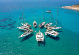 Stunning Aerial View of Sailing Boats in Turquoise Tropical Bay Arranged in a Star Formation