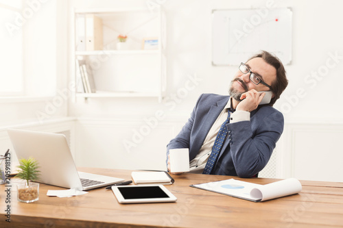 Serious businessman having phone talk