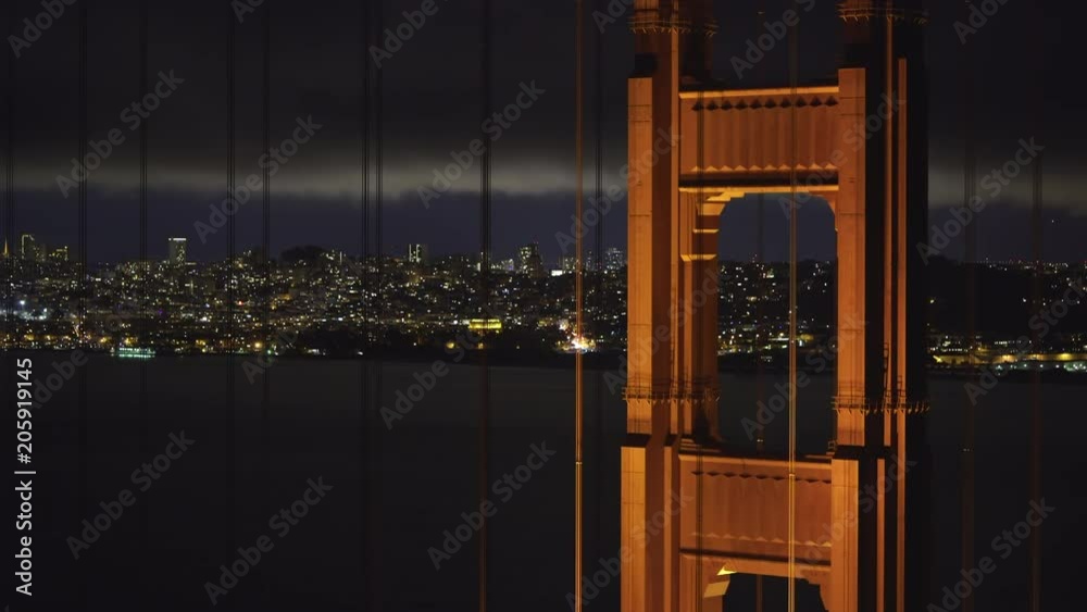 San Francisco lights through Golden Gate bridge at night - August 2017: San Francisco, California, US