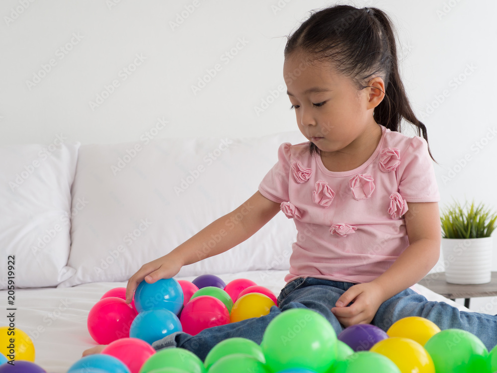 Obraz premium young Asian Kid playing colorful ball.