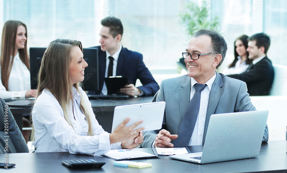 employees using digital tablet to work with financial data employees using digital tablet to work with financial data