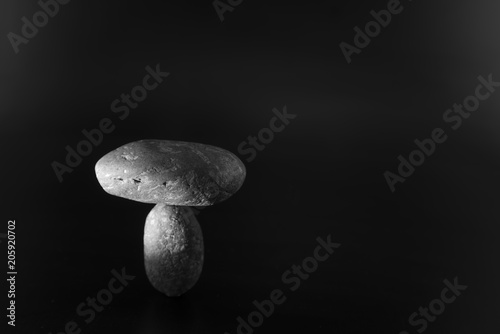 Balance the boulders concept together on a colorful background.