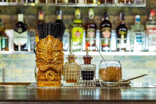 a glass tiki on the bar photo