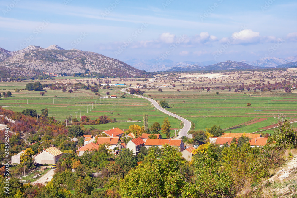 Karst field landscape.  Bosnia and Herzegovina, Zubacko polje. View of village of Grab and road to city of Trebinje