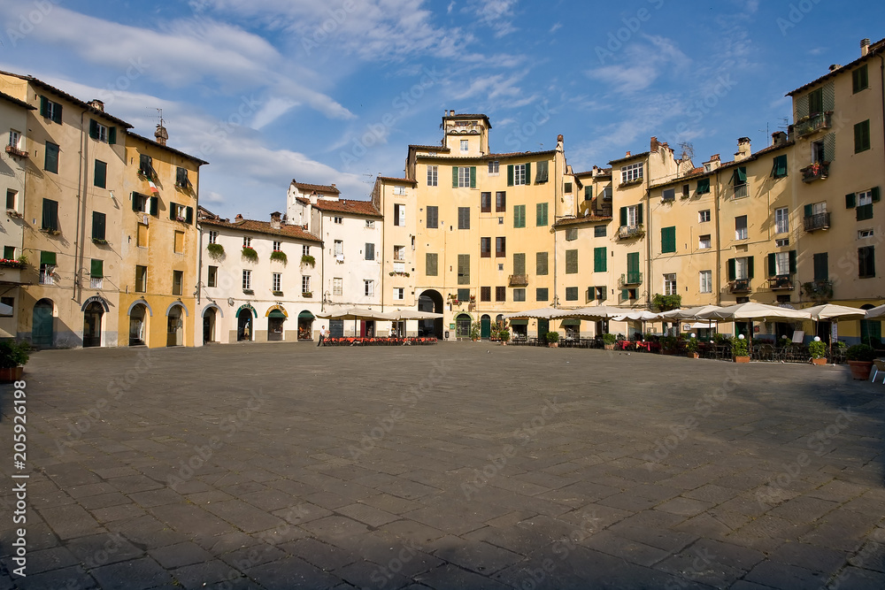 Piazza Anfiteatro in the old town of Lucca. The ring of buildings surrounding the square, follows the elliptical shape of the former Roman Amphitheater of Lucca