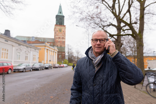 Mature handsome man enjoying life around the city of Turku, Finl photo