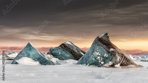 View of ice berg on sea of Spitsbergen during sunset photo