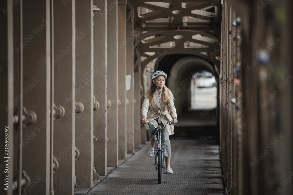 Young Female Adult Cycling over a Bridge