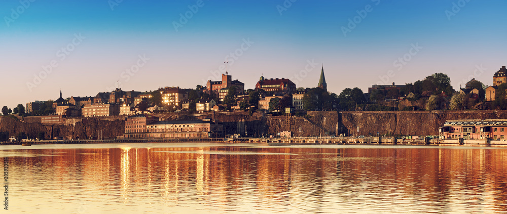 View of Stockholm city - the capital of Sweden at sunrise with water reflection.Panoramic view