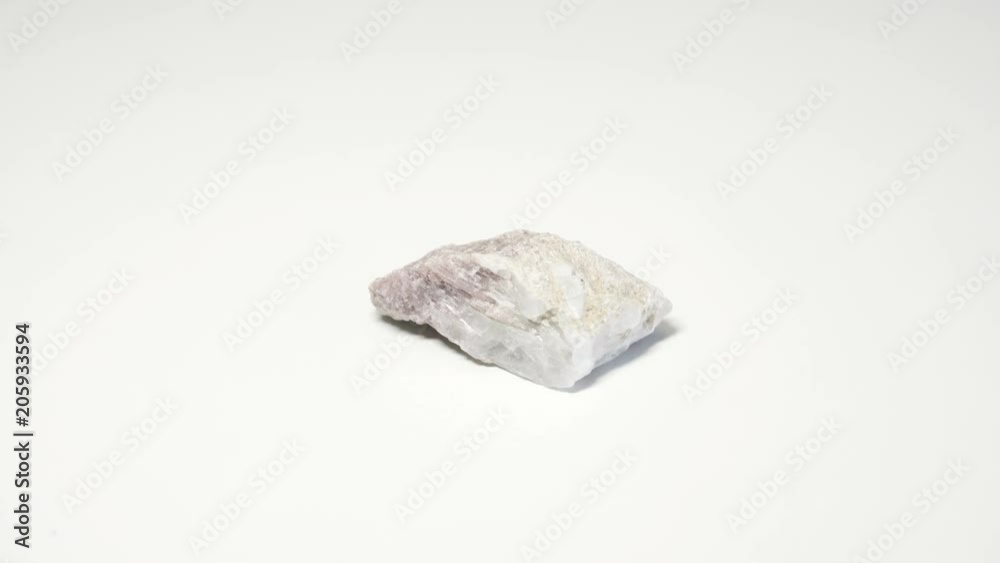 Macro shot of rubellit mineral isolated over white background and spinning around